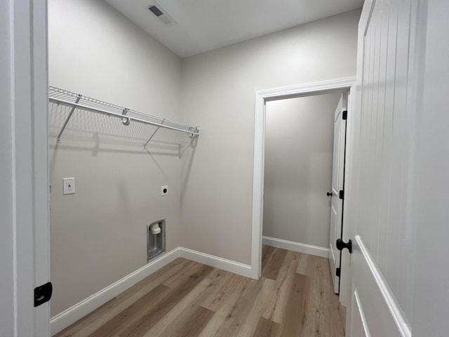 553 Sequoyah Dr, Morristown, TN 37813 - washroom with electric dryer hookup, light wood-type flooring, and baseboards