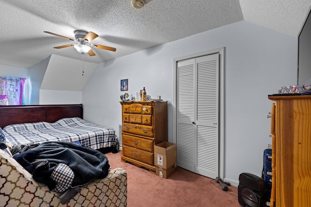 carpeted bedroom featuring lofted ceiling, a closet, and a textured ceiling