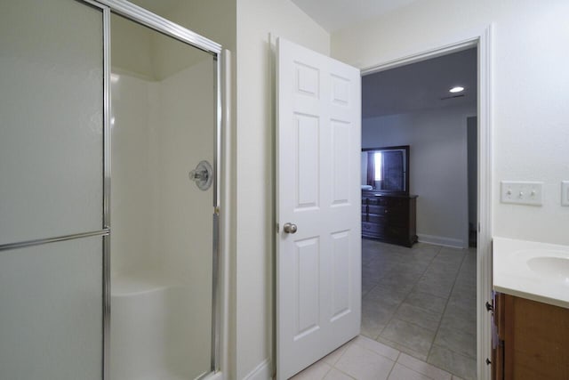 bathroom with tile patterned floors, vanity, and a shower with shower door