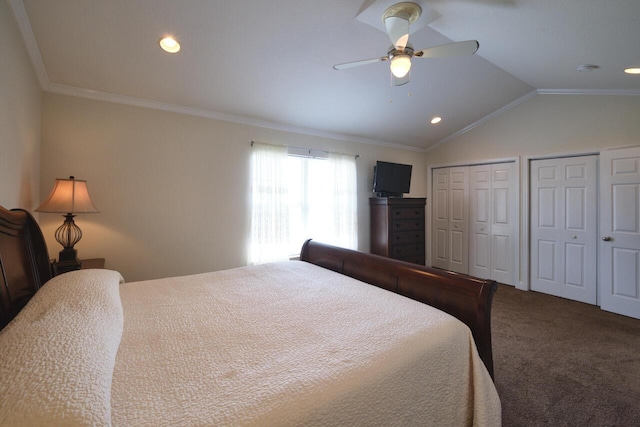 carpeted bedroom with two closets, ceiling fan, crown molding, and vaulted ceiling