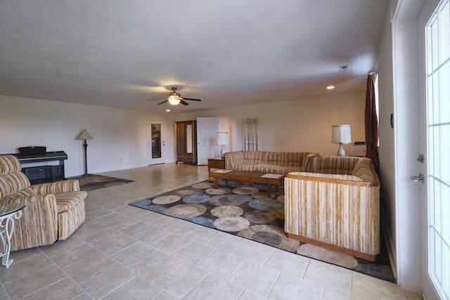 tiled living room featuring ceiling fan and a healthy amount of sunlight