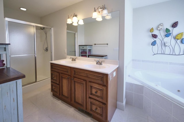 bathroom featuring tile patterned flooring, vanity, and shower with separate bathtub