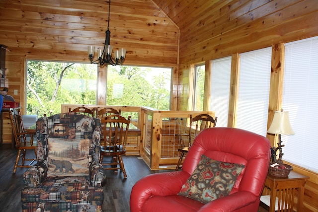 sunroom / solarium featuring vaulted ceiling and an inviting chandelier