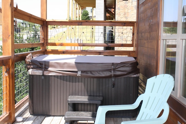 wooden terrace featuring a hot tub