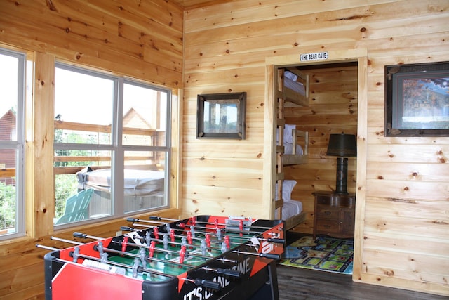 game room with wood walls