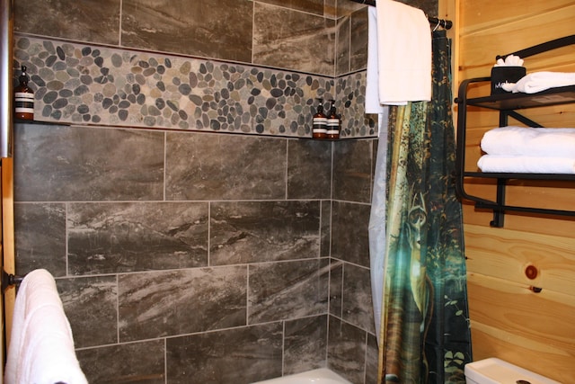 bathroom with radiator and shower / tub combo with curtain