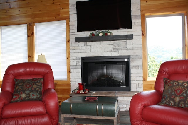 living room with wood walls and a fireplace