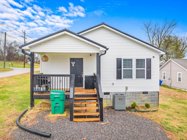 bungalow with a front yard, a porch, and central AC