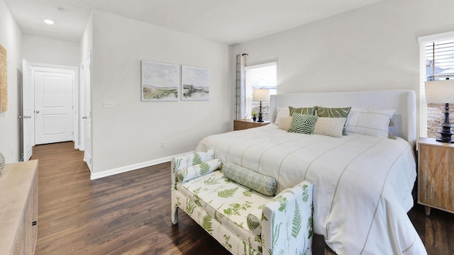 bedroom with multiple windows, wood finished floors, baseboards, and recessed lighting