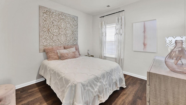 bedroom with baseboards and dark wood finished floors