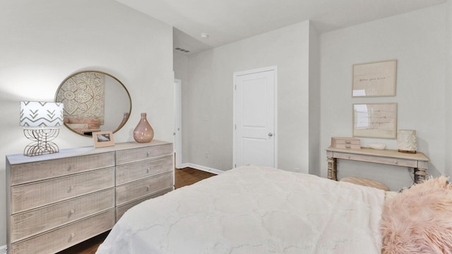 bedroom featuring dark wood-type flooring and baseboards