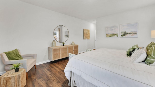 bedroom featuring wood finished floors and baseboards