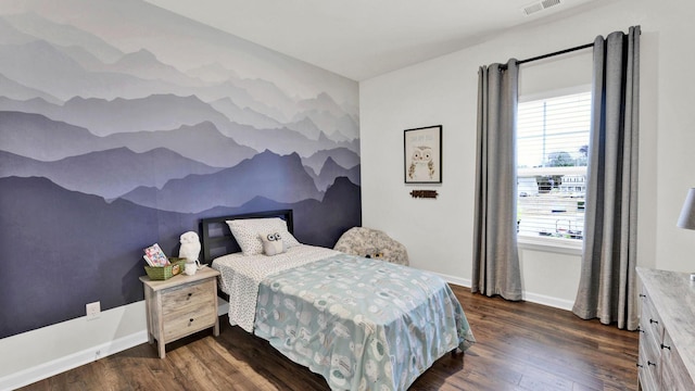 bedroom with multiple windows, dark wood finished floors, and baseboards