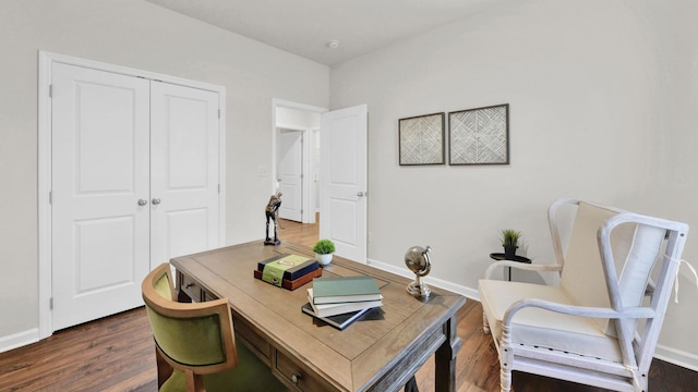 office area featuring dark wood-type flooring and baseboards