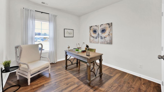 office space with dark wood finished floors and baseboards