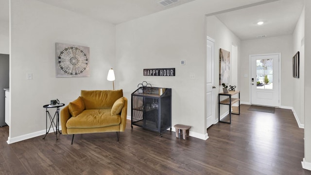 sitting room with wood finished floors and baseboards