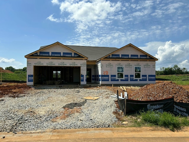 property under construction featuring an attached garage and driveway