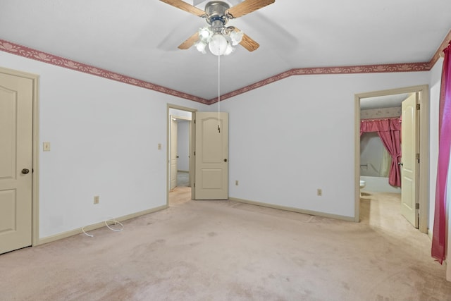 unfurnished bedroom featuring ceiling fan, light colored carpet, and connected bathroom