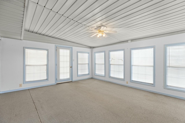 unfurnished sunroom with ceiling fan