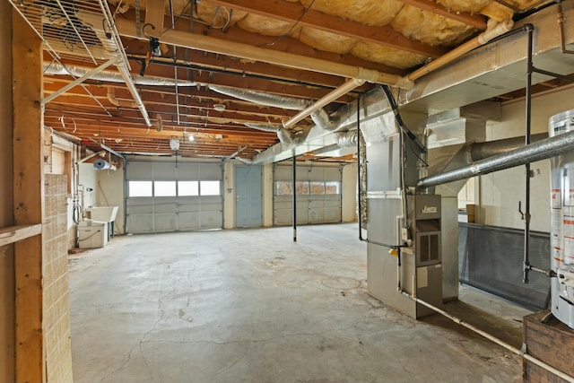 garage featuring heating unit and sink