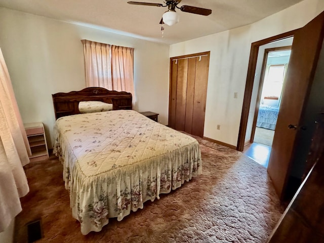 carpeted bedroom featuring a closet and ceiling fan