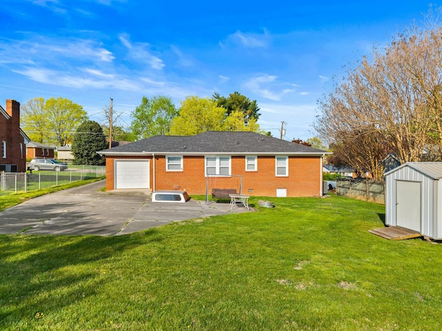 rear view of property with a shed, an outbuilding, a garage, brick siding, and fence private yard