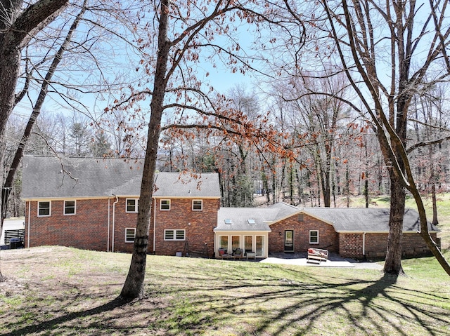 45 Link Hills Cir, Greeneville, TN 37743 - back of property featuring brick siding, a patio area, and a lawn