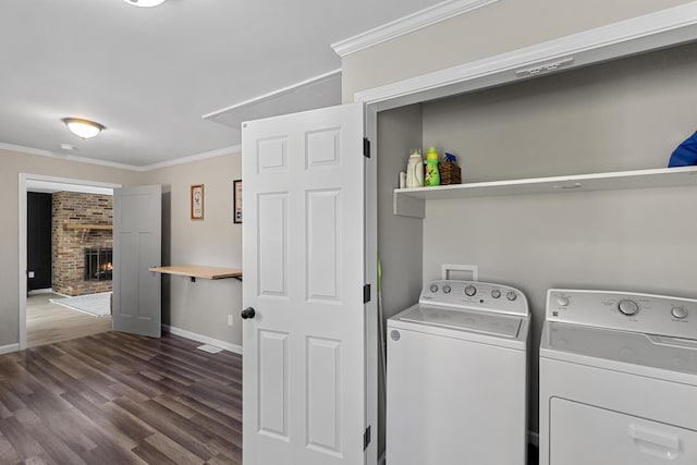 45 Link Hills Cir, Greeneville, TN 37743 - laundry room featuring separate washer and dryer, crown molding, dark wood finished floors, baseboards, and a fireplace