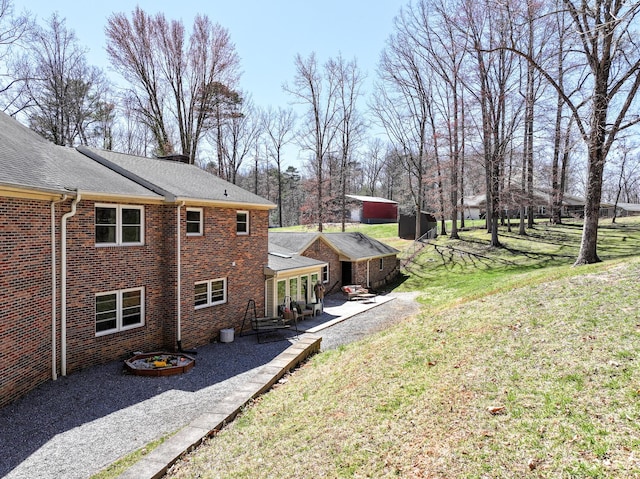 45 Link Hills Cir, Greeneville, TN 37743 - view of property exterior featuring a patio, a lawn, brick siding, and a shingled roof