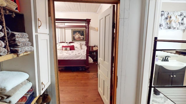 hall featuring sink and wood-type flooring