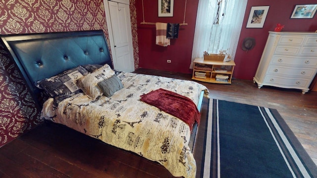 bedroom featuring dark hardwood / wood-style flooring and a closet