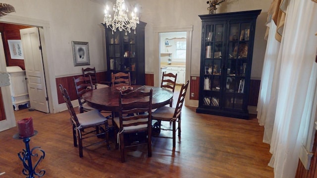 dining area featuring a chandelier and dark hardwood / wood-style floors