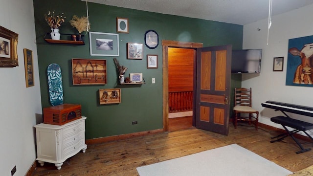 interior space with wood-type flooring and a textured ceiling