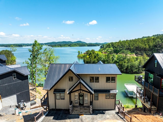 modern farmhouse style home featuring a water view