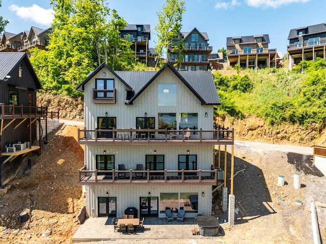 back of property featuring a patio area and a balcony