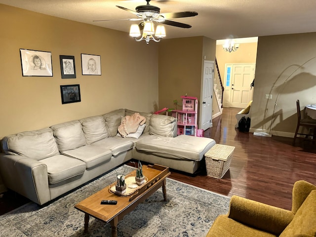 living room featuring a textured ceiling, dark hardwood / wood-style flooring, and a notable chandelier