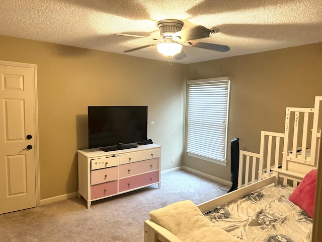 carpeted bedroom with a textured ceiling and ceiling fan