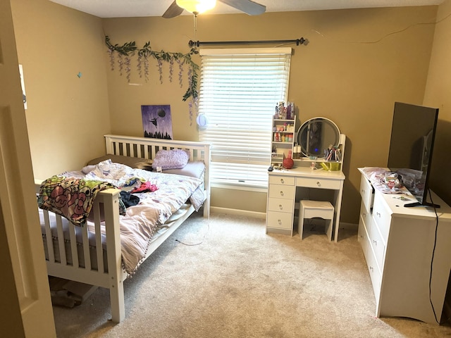 bedroom with ceiling fan and light colored carpet