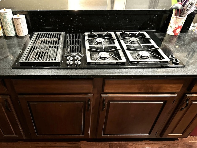 interior details featuring dark brown cabinetry and gas stovetop