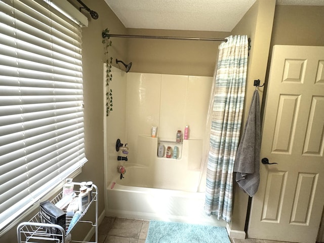 bathroom with tile patterned flooring, shower / bathtub combination with curtain, and a textured ceiling