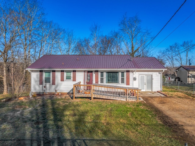 single story home with fence, a front lawn, and metal roof