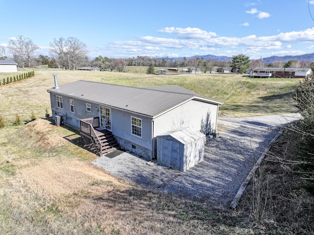 1554 Old Parrotsville Hwy, Parrottsville, TN 37843 - view of front of house with a storage unit, an outbuilding, metal roof, and a mountain view