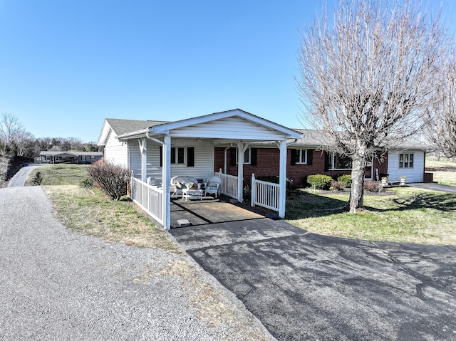 1554 Old Parrotsville Hwy, Parrottsville, TN 37843 - view of front of house with asphalt driveway, covered porch, a front lawn, a carport, and brick siding