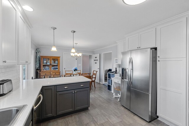1554 Old Parrotsville Hwy, Parrottsville, TN 37843 - kitchen with appliances with stainless steel finishes, a peninsula, white cabinets, and ornamental molding