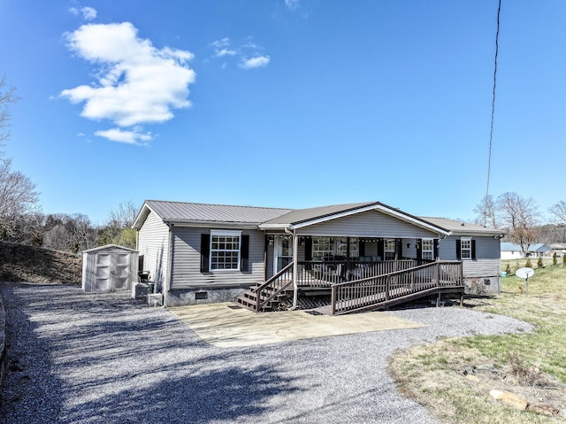 1554 Old Parrotsville Hwy, Parrottsville, TN 37843 - manufactured / mobile home featuring covered porch, crawl space, a storage unit, metal roof, and an outbuilding