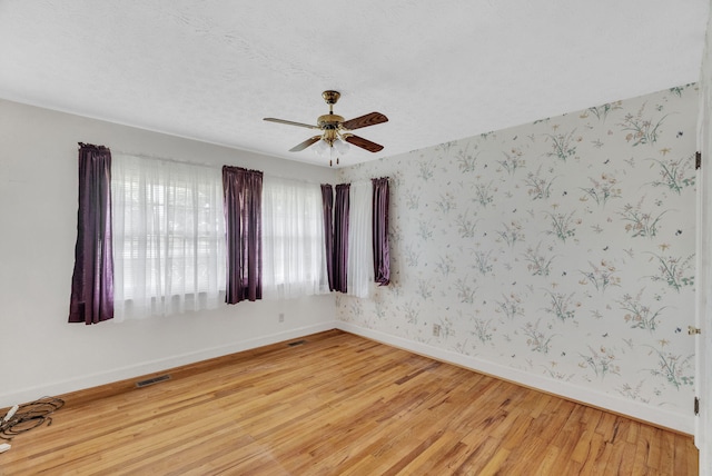 unfurnished room featuring light wood-type flooring and ceiling fan