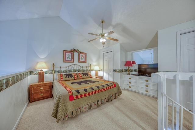 bedroom with vaulted ceiling, carpet flooring, and a ceiling fan