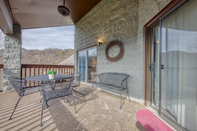 balcony featuring outdoor dining space and a sunroom