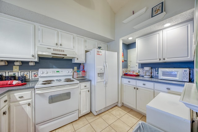 kitchen with white appliances, white cabinetry, under cabinet range hood, and light tile patterned floors