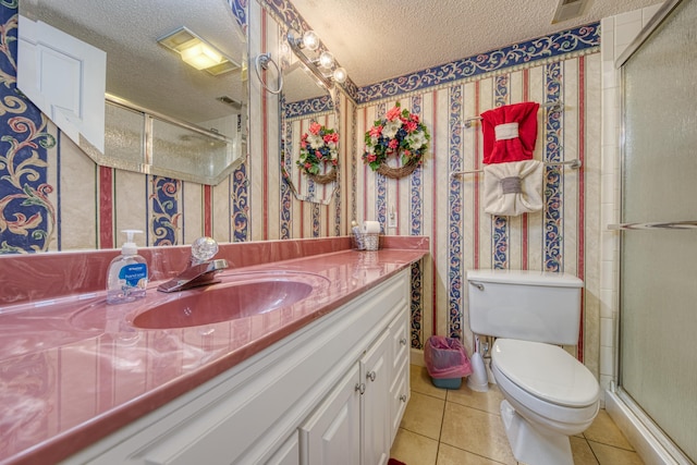 full bath with tile patterned flooring, a textured ceiling, a shower stall, and vanity